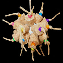 Load image into Gallery viewer, Two dozen cork stoppers with pony beads tied onto a perforated golf ball base with twisted paper cord. The toy hangs from a strip of veggie tanned leather lace. Designed for intermediate sized birds such as small conures, cockatiels, quakers, ringnecks, etc. up to slightly bigger birds that like softer textured toys. Measures approx 5" by 10" including link.