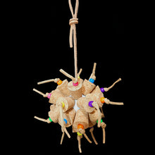 Load image into Gallery viewer, Another exciting toy for the cork lovers! Two dozen cork stoppers with pony beads tied onto a perforated golf ball base with twisted paper cord. The toy hangs from a strip of veggie tanned leather lace. Designed for intermediate sized birds such as small conures, cockatiels, quakers, ringnecks, etc. up to slightly bigger birds that like softer textured toys. Measures approx 5&quot; by 10&quot; including link.

