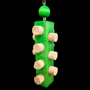 Easy to chew cork stoppers inserted into all sides of a brightly colored 1-1/4" by 6" pine block base topped off with a hardwood ball. Hangs from nickel plated hardware.  Measures approx 2-1/2" by 9" including link.