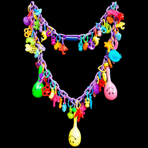 Does your bird love to play with your zipper, buttons or jewelry? If so, both of you will love this necklace made just for them! Designed to be worn around your neck so your bird can play while on you. Made with plastic chain, lots of charms and three mini maracas, this bird-safe necklace is sure to be a hit for birds and bird parents alike! Available in different color combinations (no two will be alike).