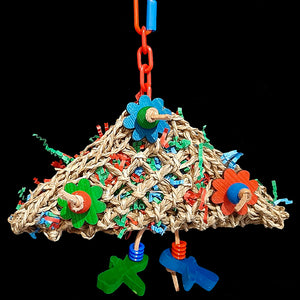 Lots of foraging fun with this toy! A seagrass pouch filled with crinkle paper and adorned with brightly colored pine daisies, wood beads and dragonflies attached with veggie tanned leather lace. Stuff extra treats inside and watch the fun begin! Designed for birds of all sizes.  Measures approx 10" by 10" including chain and link.