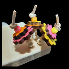 Load image into Gallery viewer, A 3/4" thick pine wood platform corner perch with brightly colored pine daisies on veggie tanned leather lace sprouting of the corner. A great alternative perching spot for birds with special needs or a different place for resting tired feet! Many birds will also enjoy chewing on the wood, providing hours of entertainment and beak exercise.