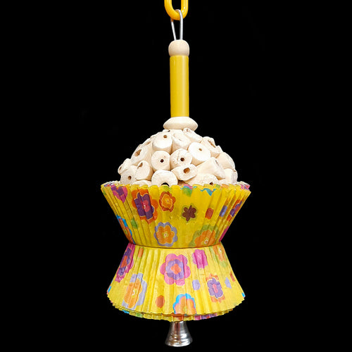 A super soft sola atta ball nestled inside colorful paper cupcake liners with a cork stopper hidden under the bottom liners. Strung on stainless steel wire with a plastic straw bead, wood beads and small nickel plated bell at the bottom. Designed for small birds such as parrotlets, budgies, small conures, cockatiels, etc.  Measures approx 3