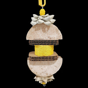 Created and named for a special little bird who loves softer textures! Made with yucca slices, cardboard cutouts, crunchy palm leaf bows and a colored loofah slice threaded on stainless steel wire. Will be loved by small to intermediate sized birds who like softer materials.  Measures approx 3-1/2" by 10" including link.