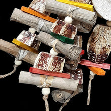 Load image into Gallery viewer, Your bird will think it's hit the jackpot with this toy! The base is a 3 - 3-1/2" yucca round with six arms of banana leaf rolls, mahogany chunks, brightly colored mini pine wood slats and wood snap beads strung on jute cord. At the bottom are two large mahogany pods with more pine slats and snap beads.