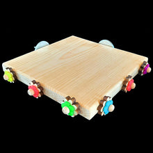 Load image into Gallery viewer, Untreated pine platform corner perch with spinning daisies measuring 7" by 7" by 3/4" thick. A great alternative perching spot for birds with special needs or just a different place for resting tired feet! Many birds will also enjoy chewing on the wood, providing hours of entertainment and beak exercise. Designed for small to medium sized birds.