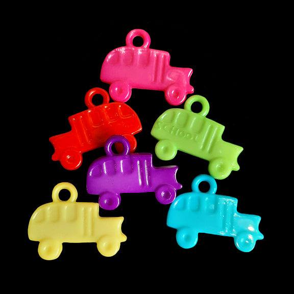Double sided acrylic charms in the shape of a school bus measuring approx 1