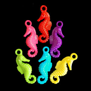 Acrylic charms in the shape of a seahorse measuring approx 1/2" by 1-1/4" with a 3mm (approx 1/8") hole. 