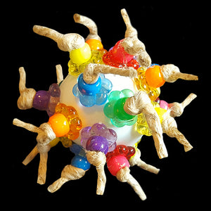 Lots of brightly colored pony beads and crystal stringing rings knotted onto a plastic golf ball with jute cord.  Designed as a foot toy for medium to large birds or as a cage top toy for the smaller guys.