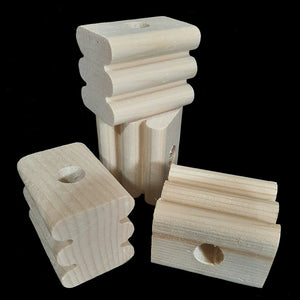 Natural, uncolored pine wood blocks measuring approx 1-1/2" by 2" by 1-5/8" high with a 1/2" hole. The blocks have rounded grooves making them easier for birds to chew.