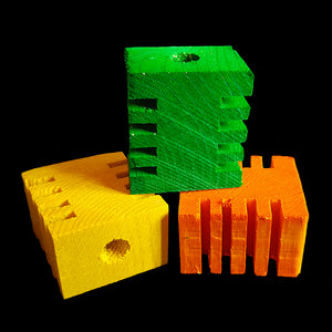 Brightly colored pine blocks measuring approx 1-3/4" by 1-1/2" by 1" with a 3/8" center hole. The blocks have grooves in two sides for easy chipping.