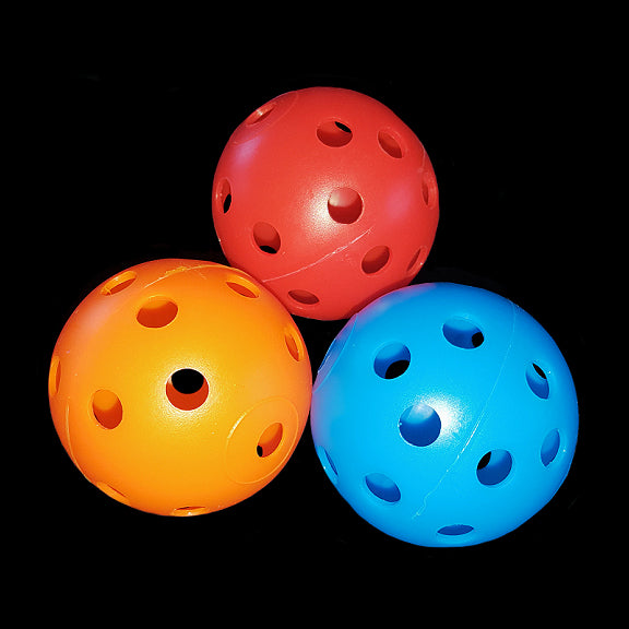 Lightweight, perforated plastic golf balls with holes measuring approx 1/4