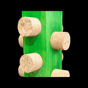 Easy to chew cork stoppers inserted into all sides of a brightly colored 1-1/4" by 6" pine block base topped off with a hardwood ball. Hangs from nickel plated hardware.  Measures approx 2-1/2" by 9" including link.