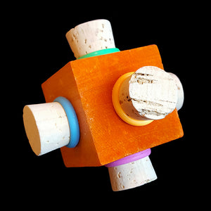 Corks with rubber rings stuffed into each side of a brightly colored pine cube. Designed for medium and large birds.  Measures approx 2-1/2".
