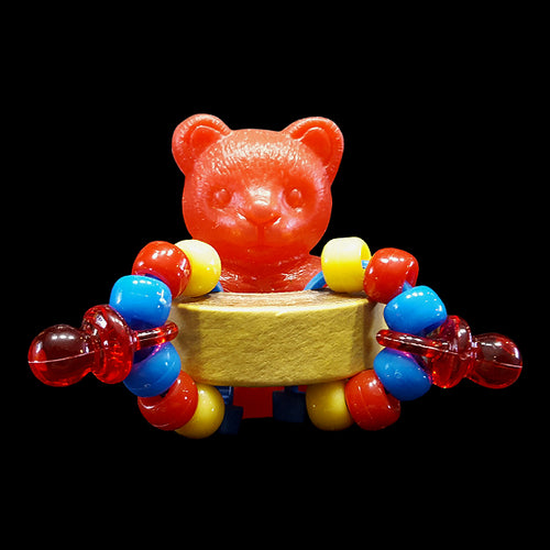 A hollow plastic bear sitting inside a chubby bagel adorned with pony beads and mini pacifiers. It's like four foot toys rolled into one! Designed for intermediate to medium birds.  Measures approx 2