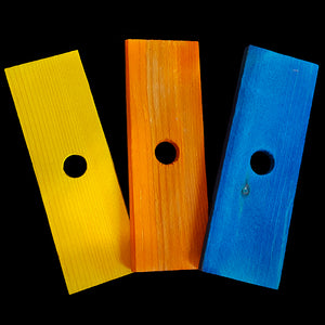 Brightly colored soft wood pine slats measuring 1-1/2" by 3-1/2" by 1/4" thick with a 1/2" hole.