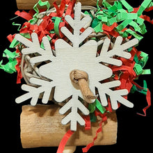 Load image into Gallery viewer, Bird toy with a  2-1/2&quot; vine ball stuffed with Christmas paper shred sandwiched between two super soft sola sticks. Thin wood snowflakes adorn the vine ball on two sides. Strung on paper twist cord. Designed for small to intermediate sized birds.
