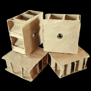 Corrugated cardboard honeycomb blocks measuring 1-1/2" by 1-1/2" by 3/4" with a 1/4" hole.