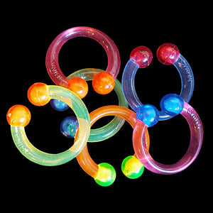 Crystal colored hard plastic rings just under 1" in size. They have just enough spring to fit a small bead to close the gap. Great for sugar glider toys!