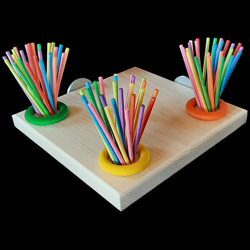 A natural pine wood platform corner perch with lots of colored paper lollipop sticks to unravel and wood rings to chew and spin. Platform measures 7