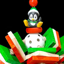 Load image into Gallery viewer, Christmas bird toy with pine slats on jute cord on a perforated golf ball with a cute Christmas penguin seated on the top.
