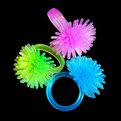 Soft rubbery rings with a spiny pom-pom. The large loop makes them easy to string on toys or stuff with parts. Birds love tugging and chewing off the little spines!