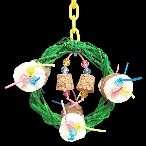 A four inch vine ring wreath adorned with super soft sola coins, small cork stoppers and little beads strung on plastic lacing cord. Hangs from a length of plastic chain. Designed for small birds such as budgies, parrotlets, lovebirds, linnies, etc.  Measures approx 4