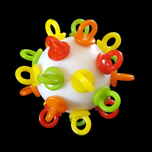 A perforated golf ball loaded with mini pacifiers & beads inside that rattle. This foot toy is great for intermediate to medium sized birds and can be easily washed by hand or in the dishwasher.  Measures approx 2-1/2".