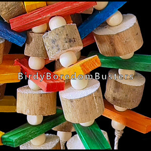 Lots of brightly colored mini pine slats, super soft sola and little wood snap beads hanging under a yucca base. Designed for birds who love soft wood and shredding. An instant hit with my budgies!  Measures approx 4" by 11" including link. 